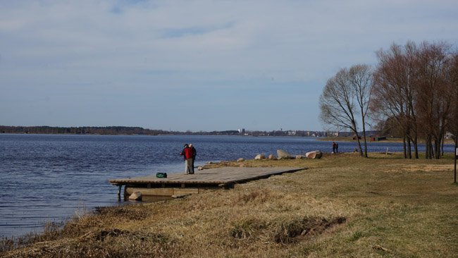 People on the shore of Riga HES reserovoir at Ikškile. 