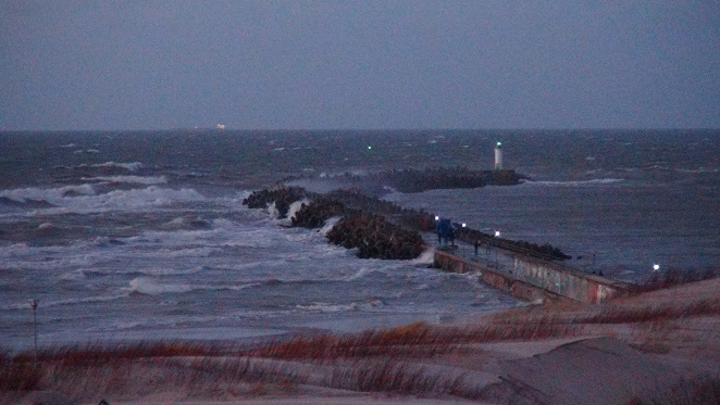 Southern pier of Ventspils during a storm, as seen from a lookout tower